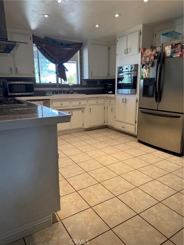 17665 Juniper St, Hesperia, CA 92345 - kitchen with light tile patterned floors, recessed lighting, exhaust hood, and stainless steel appliances