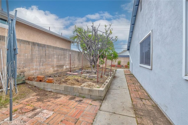 view of yard featuring a fenced backyard and a vegetable garden