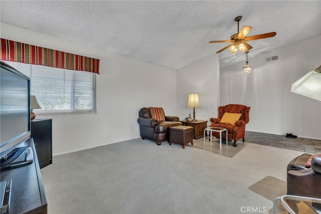 living area featuring visible vents, a textured ceiling, and carpet floors