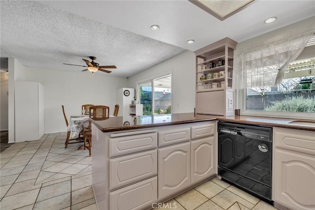 kitchen featuring open shelves, dishwasher, ceiling fan, dark countertops, and a peninsula