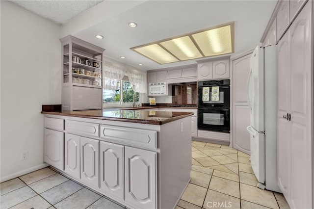 kitchen with white appliances, a peninsula, open shelves, dark countertops, and white cabinets