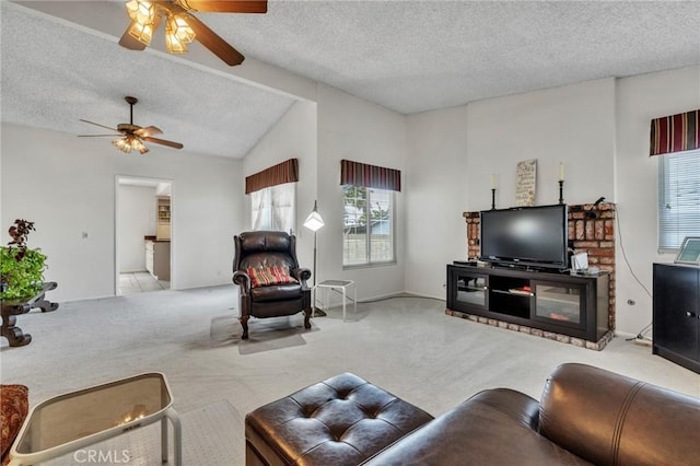 living area featuring carpet floors, ceiling fan, lofted ceiling, and a textured ceiling