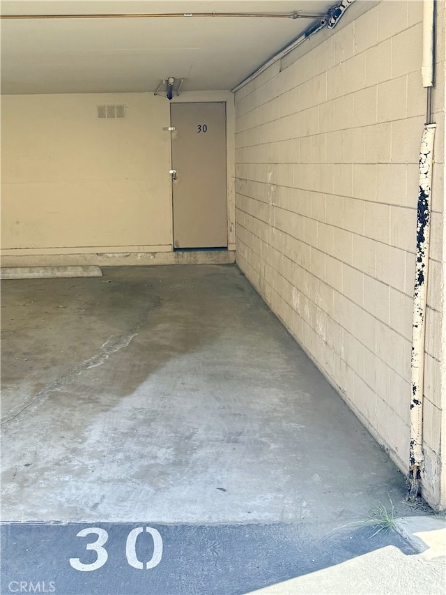 732 W Lambert Rd Unit 30, La Habra, CA 90631 - garage with visible vents and concrete block wall