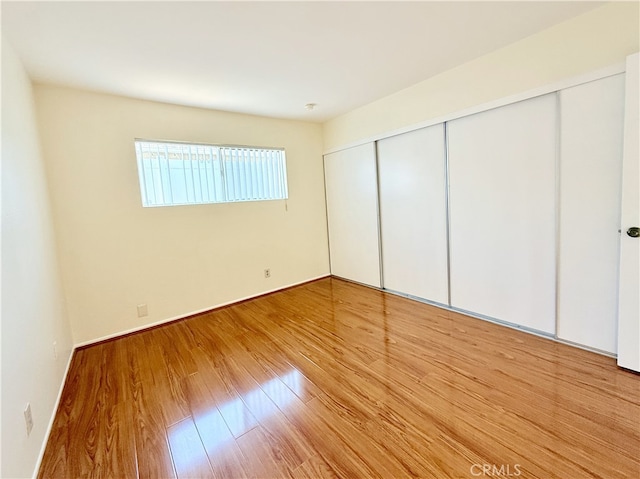 732 W Lambert Rd Unit 30, La Habra, CA 90631 - unfurnished bedroom with a closet, baseboards, and wood finished floors