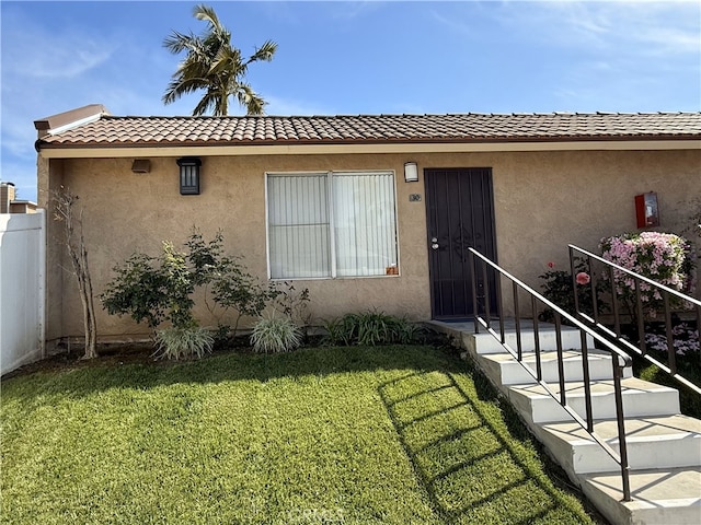732 W Lambert Rd Unit 30, La Habra, CA 90631 - view of front facade featuring a tile roof, a front yard, and stucco siding