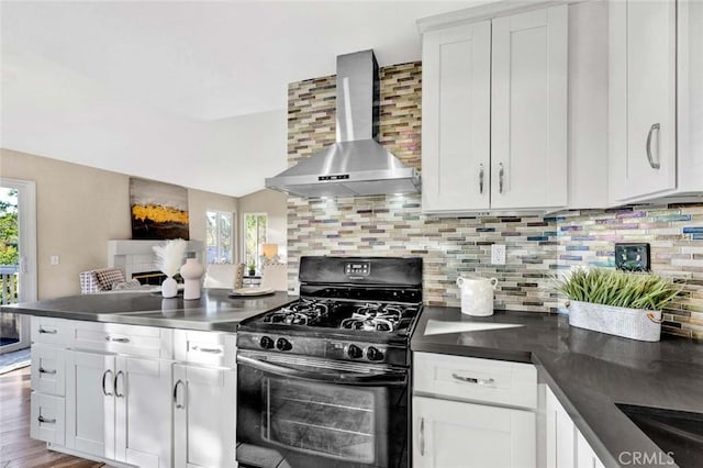 kitchen featuring backsplash, plenty of natural light, wall chimney exhaust hood, and black range with gas cooktop