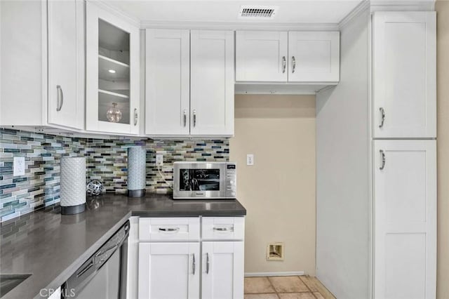 kitchen featuring glass insert cabinets, stainless steel appliances, backsplash, white cabinetry, and visible vents