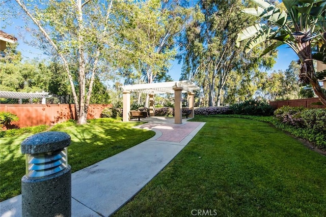 view of yard featuring a pergola, a patio area, and a fenced backyard
