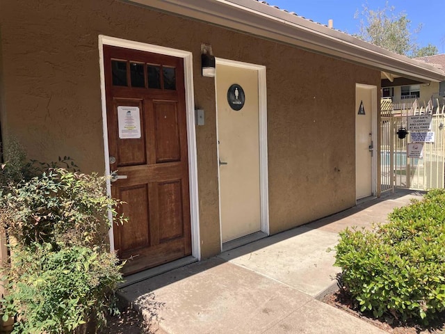 property entrance featuring stucco siding