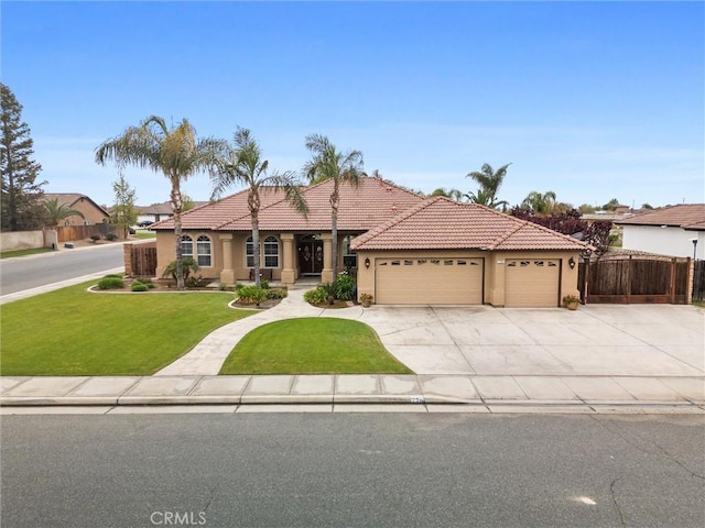 view of front of home with a tiled roof, a garage, stucco siding, and fence