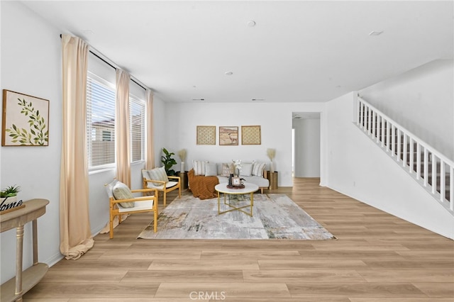 29553 Tulipwood St, Menifee, CA 92584 - living area featuring stairs, light wood-style floors, and baseboards