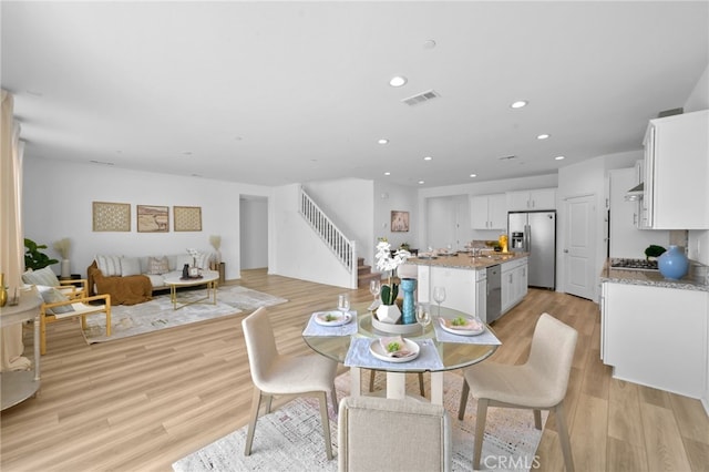 29553 Tulipwood St, Menifee, CA 92584 - dining area with light wood-style flooring, stairs, visible vents, and recessed lighting