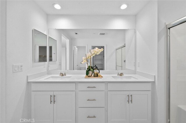 29553 Tulipwood St, Menifee, CA 92584 - bathroom with a shower stall, double vanity, visible vents, and a sink