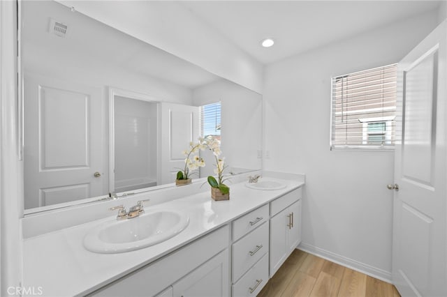 29553 Tulipwood St, Menifee, CA 92584 - full bathroom featuring double vanity, baseboards, a sink, and wood finished floors