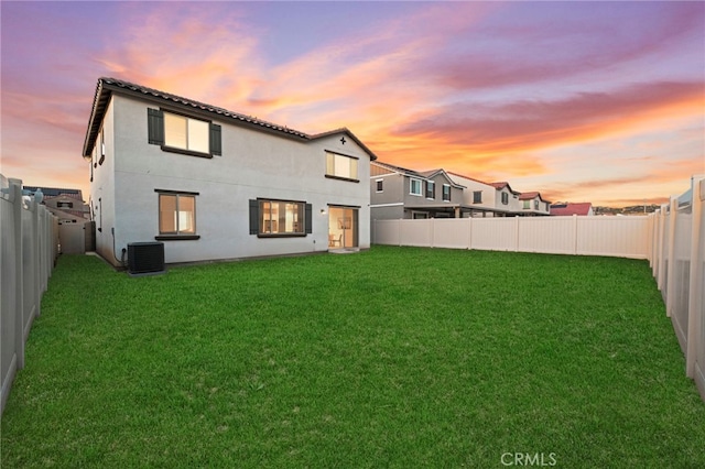 29553 Tulipwood St, Menifee, CA 92584 - back of property at dusk featuring a yard, a fenced backyard, and central AC unit