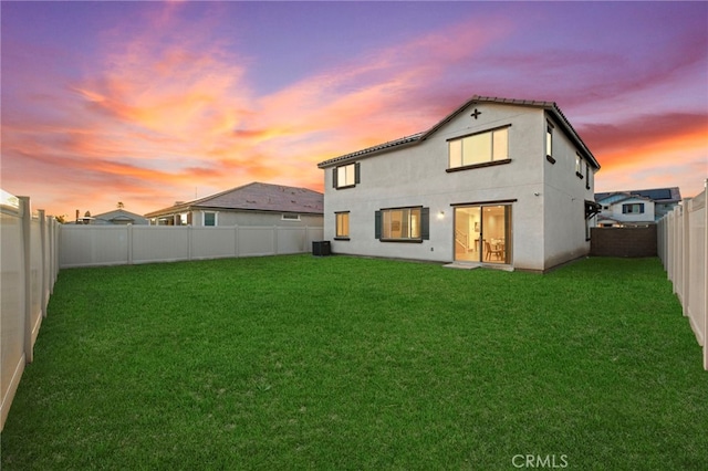 29553 Tulipwood St, Menifee, CA 92584 - back of property at dusk featuring a yard, a fenced backyard, and stucco siding