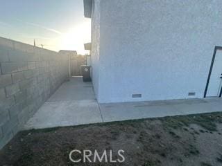 view of side of home with fence