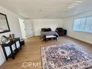 bedroom featuring light wood-type flooring and baseboards
