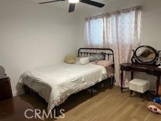 bedroom with wood finished floors and a ceiling fan