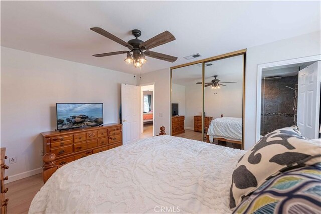 bedroom with visible vents, baseboards, light wood-type flooring, and a ceiling fan