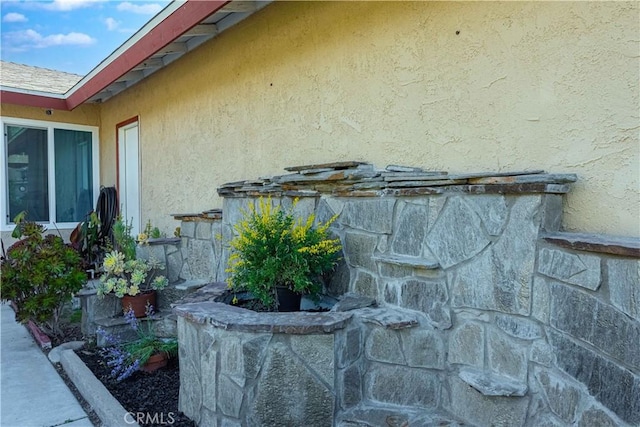 view of property exterior with a fireplace and stucco siding