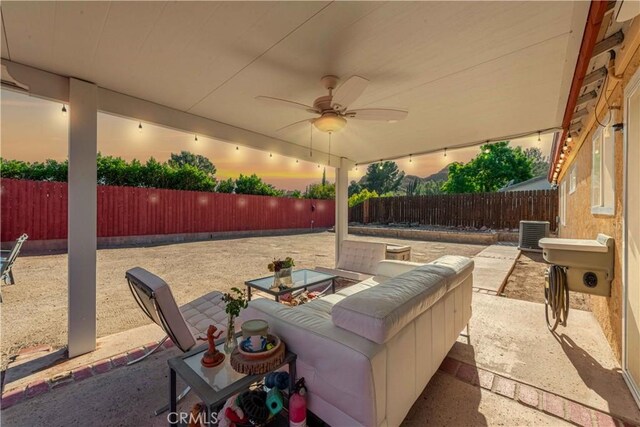 view of patio / terrace with central AC, a fenced backyard, and a ceiling fan