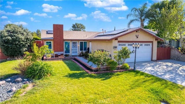 single story home with solar panels, a garage, concrete driveway, stucco siding, and a front lawn