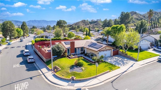 drone / aerial view featuring a residential view and a mountain view