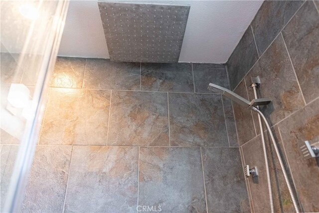 interior details with a tile shower