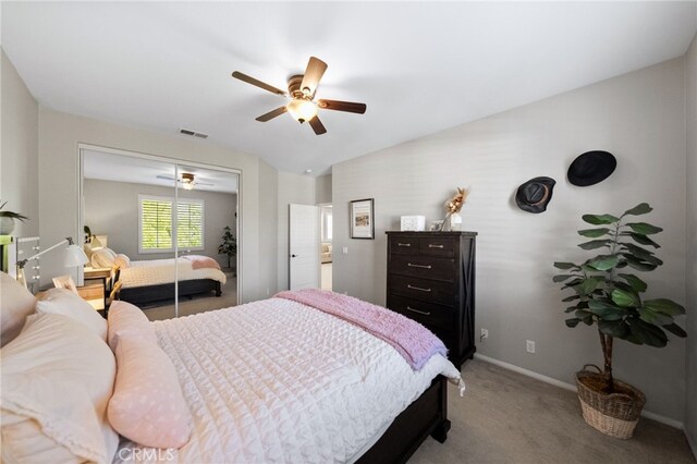 carpeted bedroom featuring baseboards, ceiling fan, a closet, and visible vents