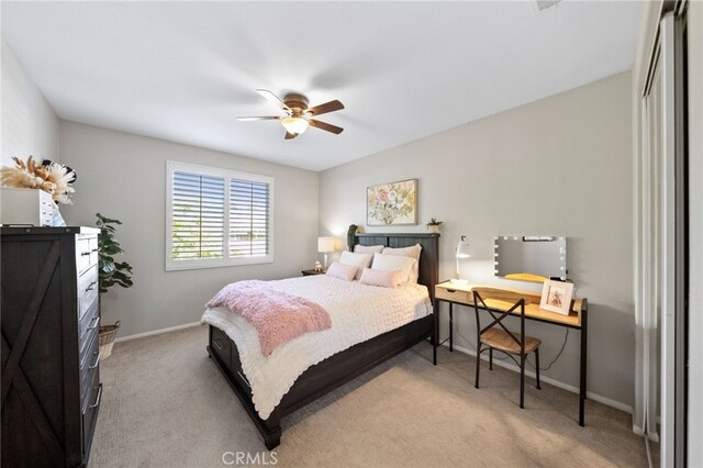 bedroom with carpet floors, baseboards, ceiling fan, and a closet