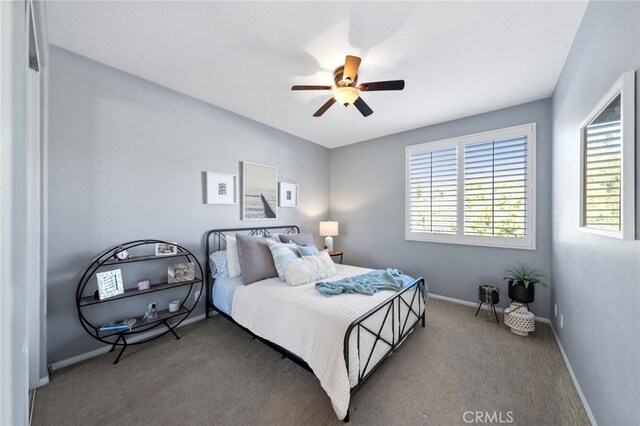 bedroom with baseboards, carpet, and a ceiling fan
