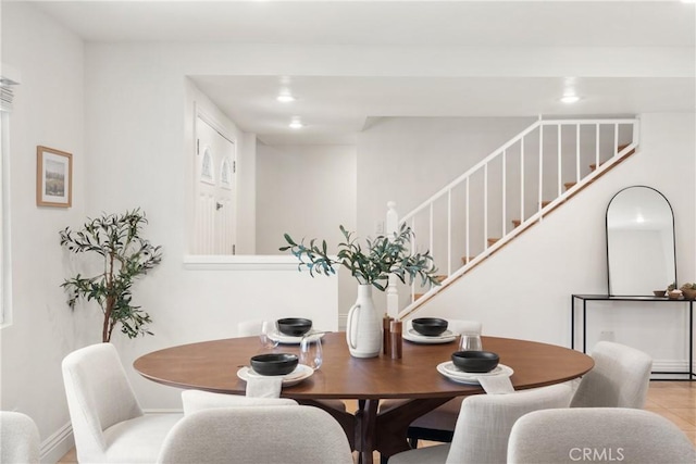 dining space with recessed lighting and stairs