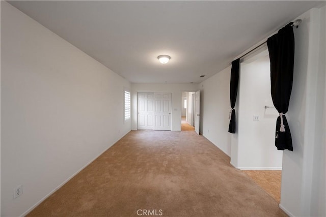 unfurnished room with light carpet