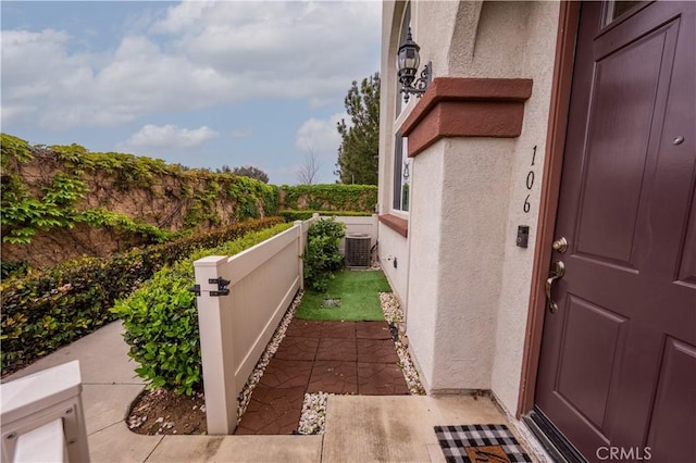 view of property exterior with central AC and stucco siding