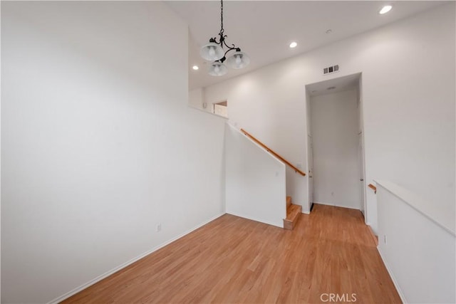 interior space with light wood finished floors, visible vents, recessed lighting, a chandelier, and stairs