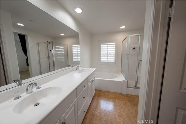 bathroom with a shower stall, a garden tub, and a sink