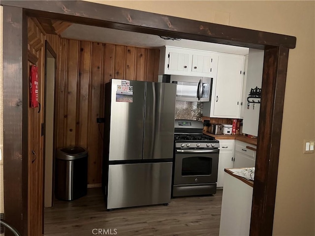 31671 Silver Spruce Dr, Running Springs, CA 92382 - kitchen with white cabinets, dark wood finished floors, and stainless steel appliances