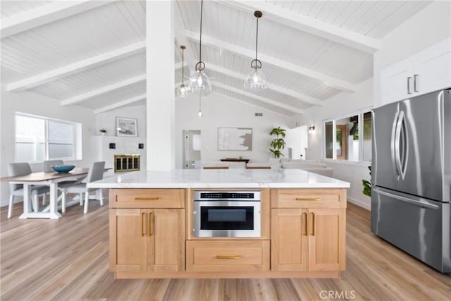 kitchen with stainless steel appliances, light countertops, light wood-style floors, open floor plan, and wooden ceiling