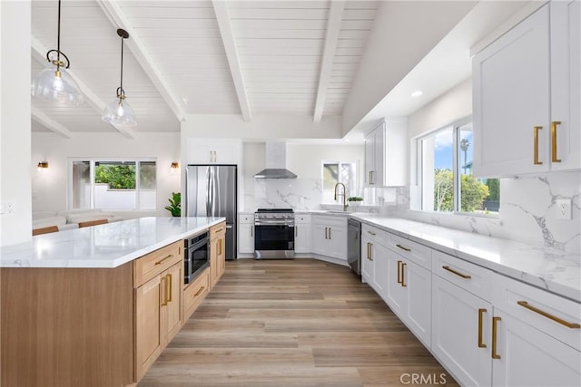 5121 Beachcomber St, Oxnard, CA 93035 - kitchen with appliances with stainless steel finishes, wall chimney range hood, healthy amount of natural light, light stone counters, and recessed lighting
