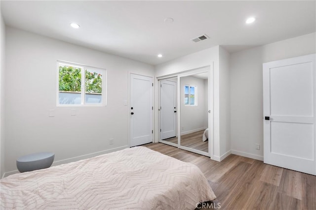 5121 Beachcomber St, Oxnard, CA 93035 - bedroom with light wood-type flooring, multiple windows, recessed lighting, and baseboards