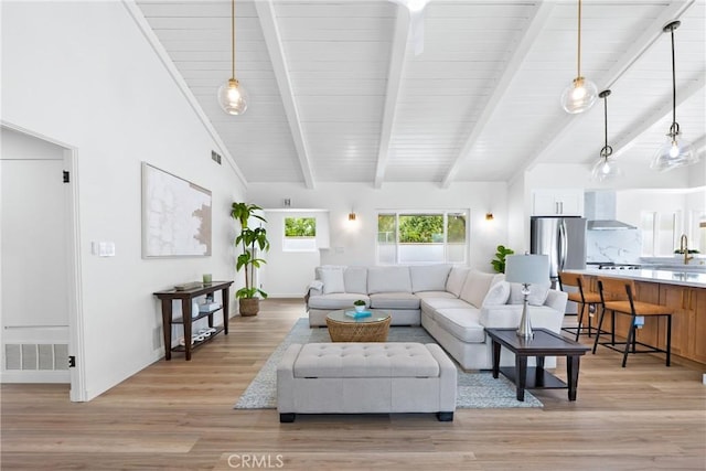 living area featuring light wood finished floors and baseboards