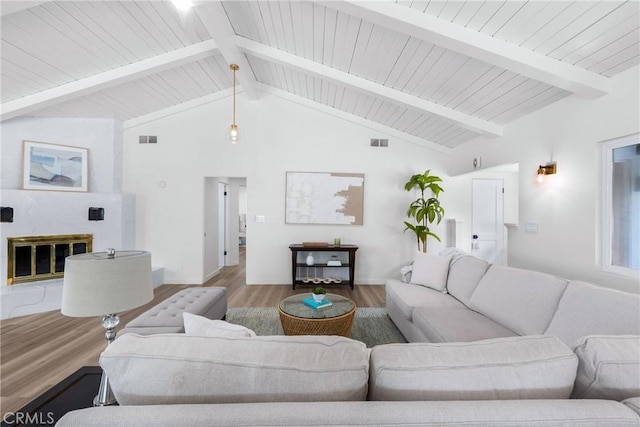 5121 Beachcomber St, Oxnard, CA 93035 - living area featuring wood finished floors, beam ceiling, a high end fireplace, high vaulted ceiling, and baseboards