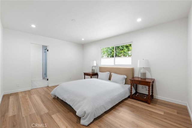 bedroom featuring light wood finished floors, recessed lighting, and baseboards
