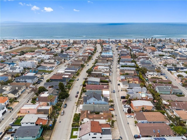aerial view of property and surrounding area with a nearby body of water and nearby suburban area