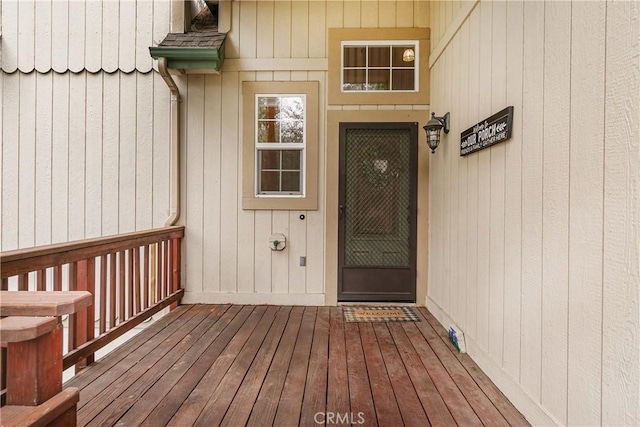 doorway to property featuring roof with shingles