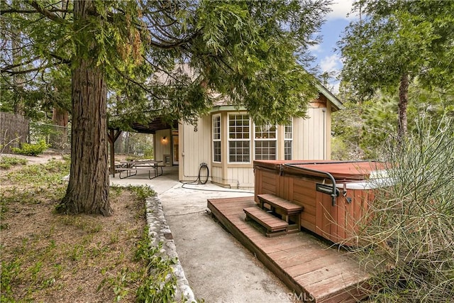 exterior space with a patio area and a hot tub
