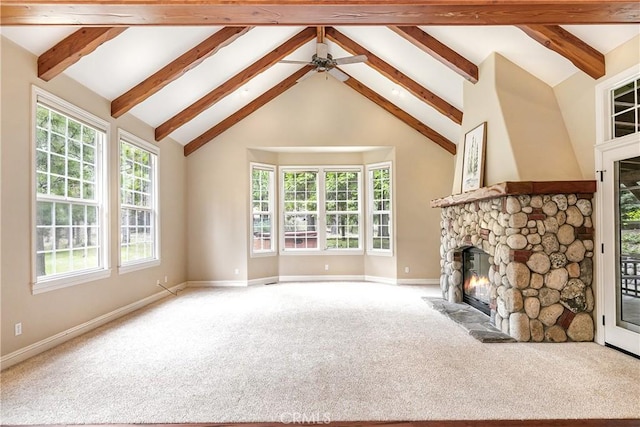 unfurnished living room with lofted ceiling with beams, carpet flooring, a fireplace, and baseboards