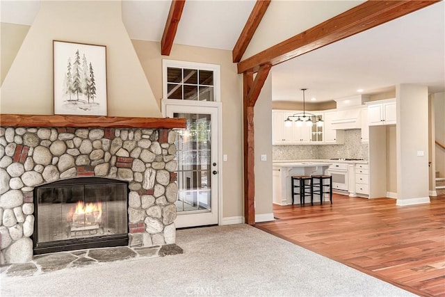 unfurnished living room with a fireplace, recessed lighting, stairway, vaulted ceiling with beams, and light colored carpet