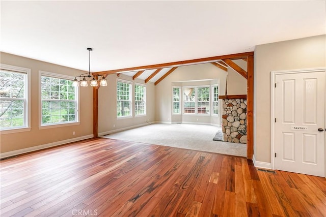 interior space with vaulted ceiling, baseboards, a chandelier, and light wood-type flooring